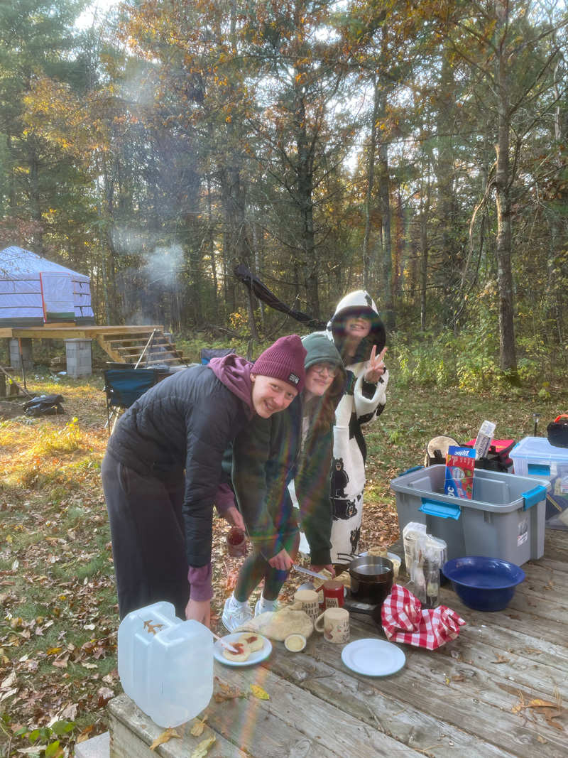 Friends preparing food together while camping